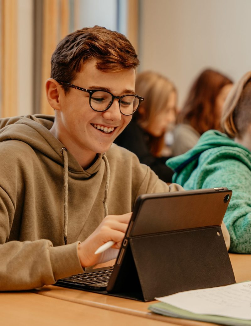 Schüler arbeitet am Tablet im ULI-Unterricht, Schulwerk Augsburg